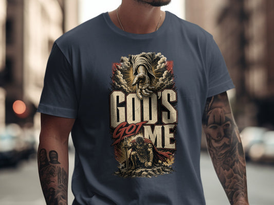T-shirt with "God's Got Me" text, divine hand, and kneeling warrior graphic.