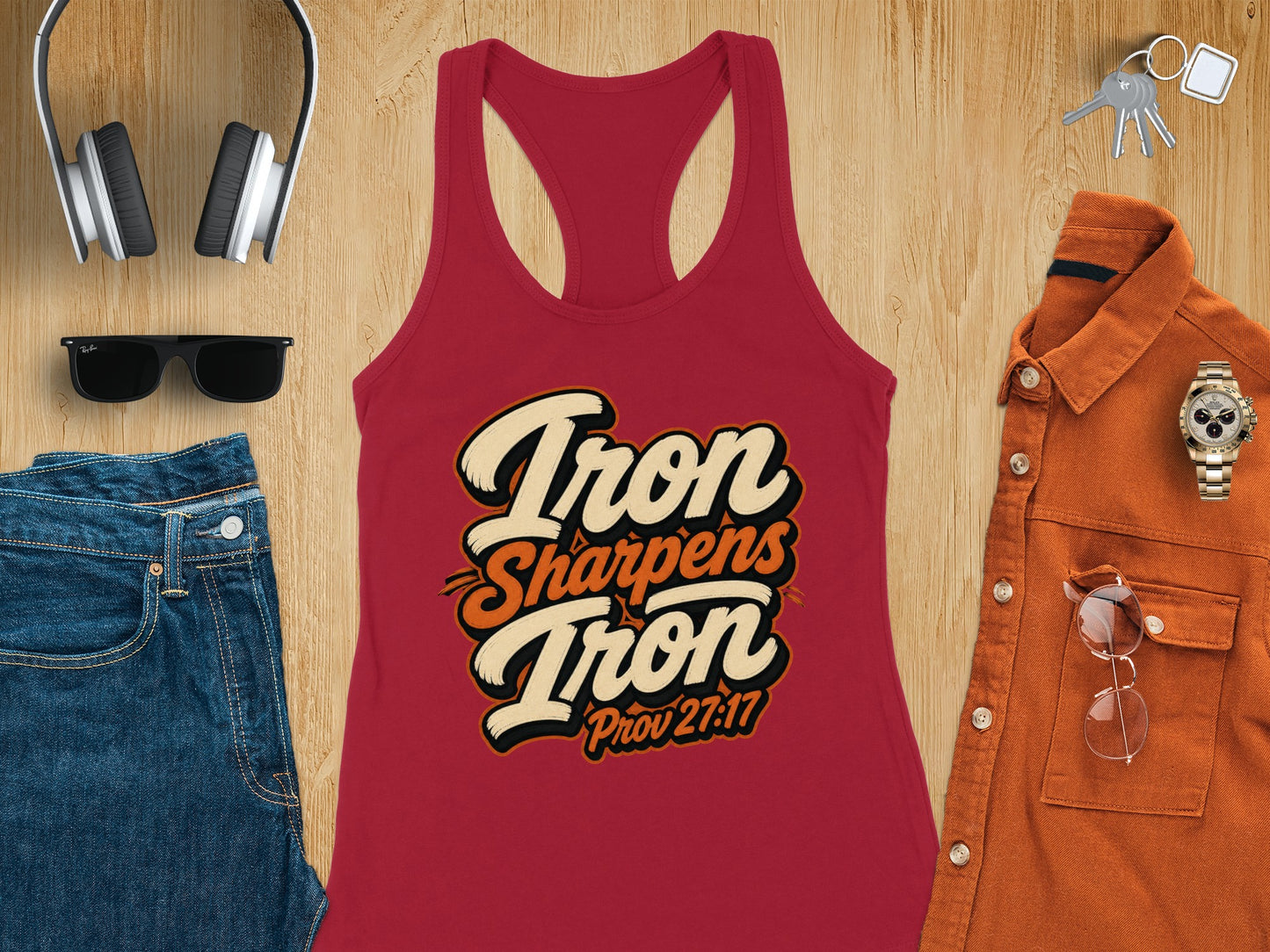 Red tank top with "Iron Sharpens Iron Prov 27:17" text, jeans, headphones, sunglasses, shirt, watch, and keys.