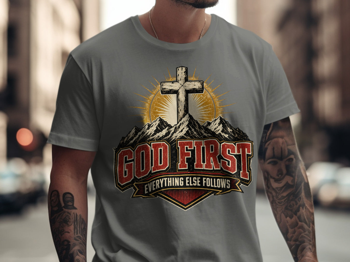 T-shirt graphic with a cross on mountains, "GOD FIRST EVERYTHING ELSE FOLLOWS" text.