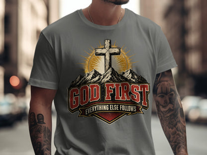 T-shirt graphic with a cross on mountains, "GOD FIRST EVERYTHING ELSE FOLLOWS" text.