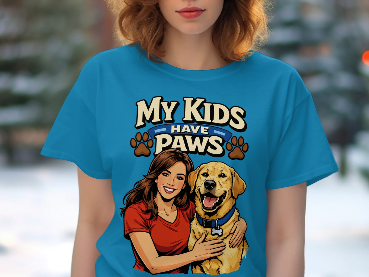 Blue t-shirt graphic with woman hugging a golden retriever and text "My Kids Have Paws".