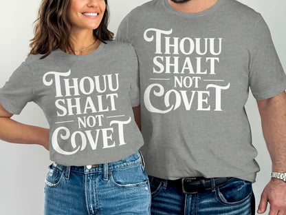 Couple wearing grey t-shirts with "Thou Shalt Not Covet" printed in white text.
