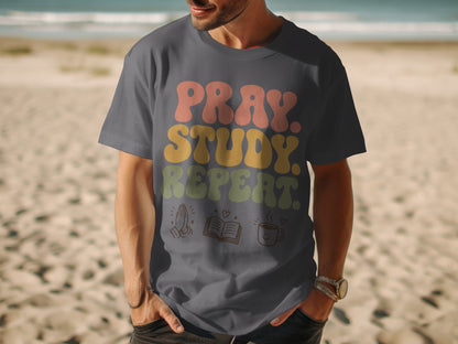 Dark grey t-shirt with "Pray. Study. Repeat." graphic and small icons.