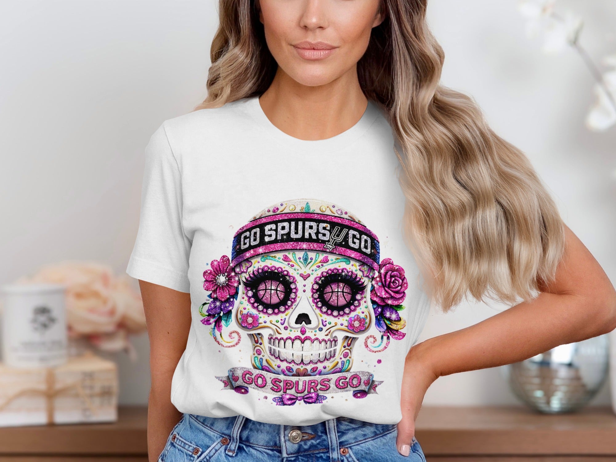 White t-shirt with a glittery skull graphic for the Spurs, featuring basketball eyes and "Go Spurs Go" text.