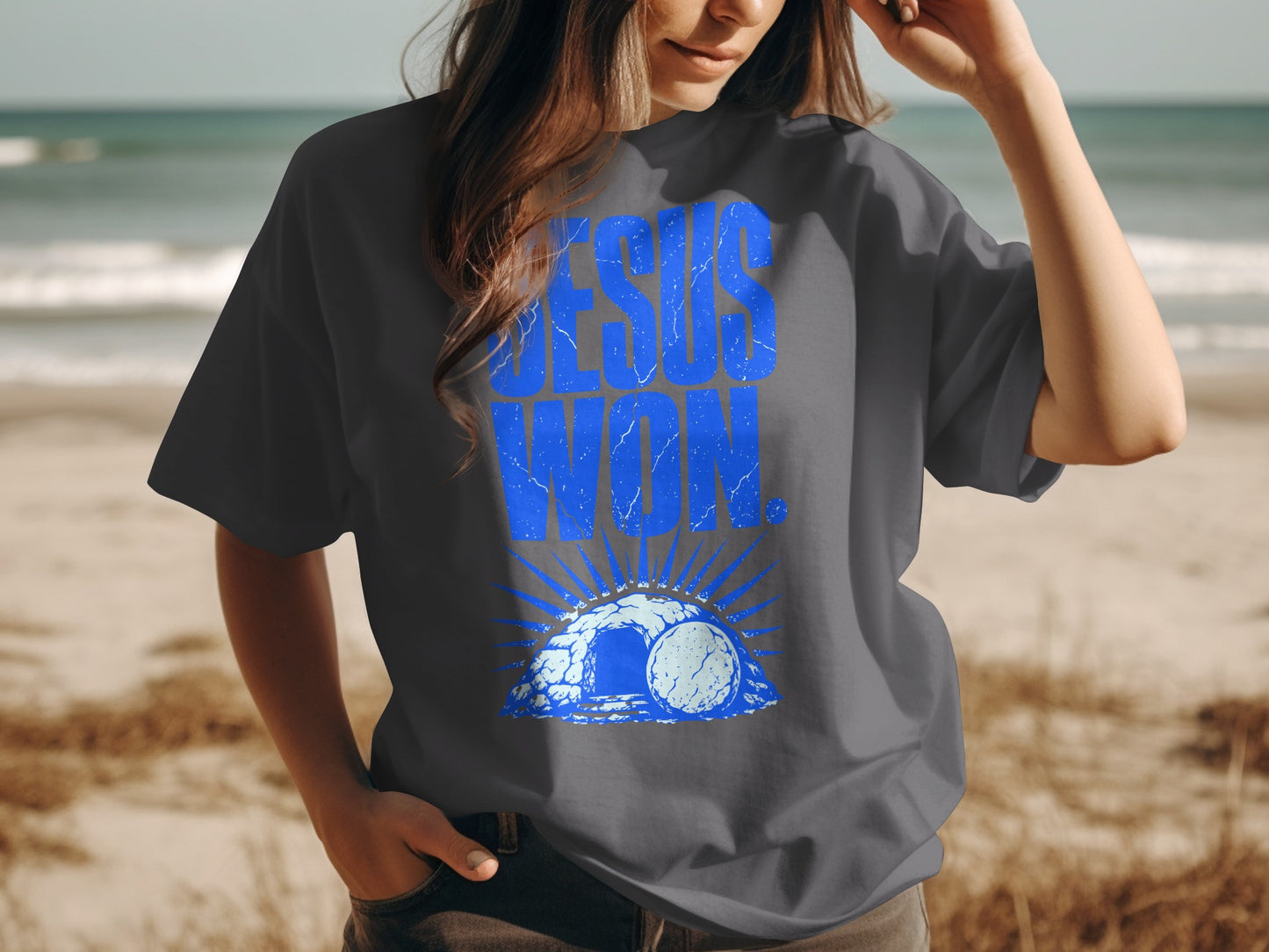 T-shirt with blue text "JESUS WON" and image of empty tomb.