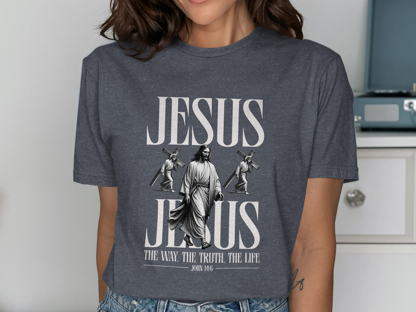 Dark gray t-shirt with graphic of Jesus, two figures carrying crosses, and text.
