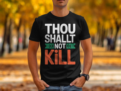 Black t-shirt with white text "THOU SHALT NOT KILL" and green arrows.