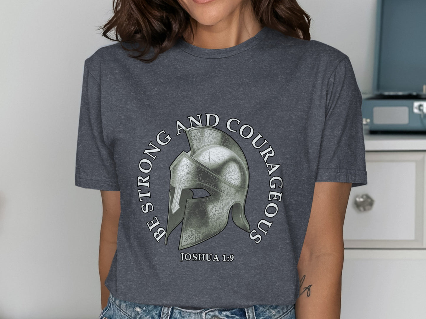 Dark gray t-shirt with a Roman helmet and text "Be Strong and Courageous Joshua 1:9".