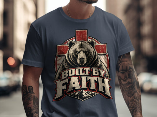 Bear and cross graphic on a t-shirt with text "BUILT BY FAITH".