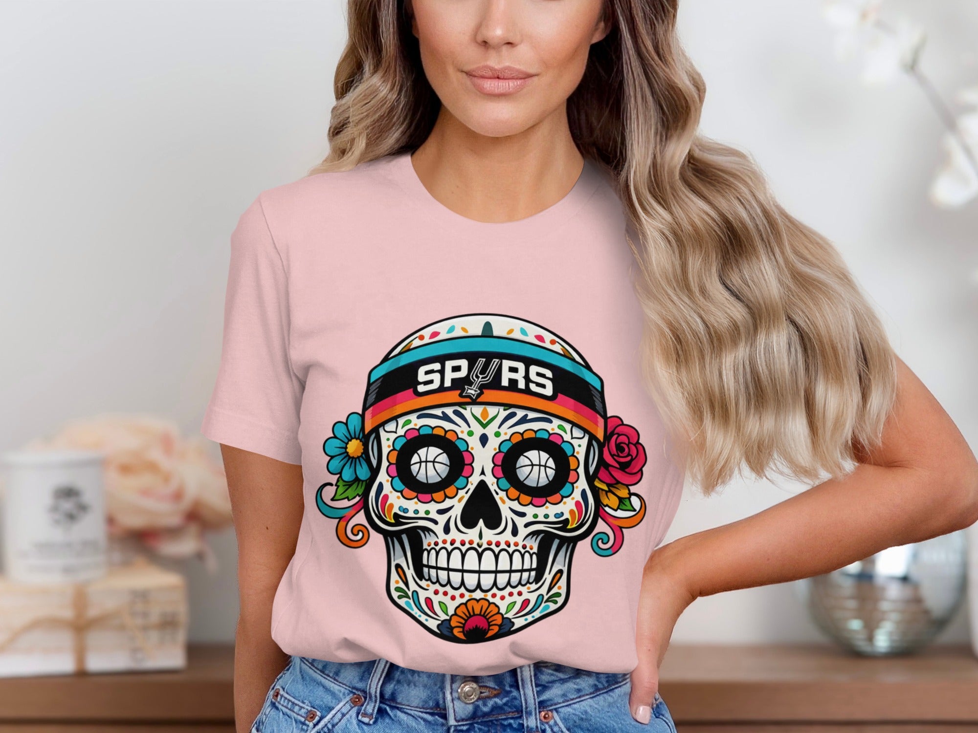 Pink t-shirt with a colorful sugar skull graphic featuring basketballs and "SPURS" text.