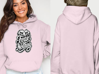 Light pink hoodie with "Fear Nothing" text and fierce animal graphic on chest.