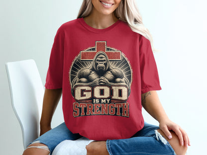 Red t-shirt with a gorilla and cross graphic that says "God Is My Strength."