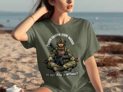 Green t-shirt with soldier meditating on front, text "Peace comes from within. Do not seek it without."
