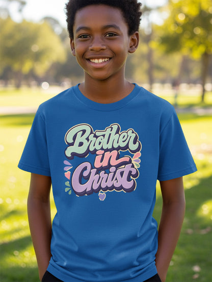 Boy wearing a blue t-shirt with "Brother in Christ" text in pastel colors.