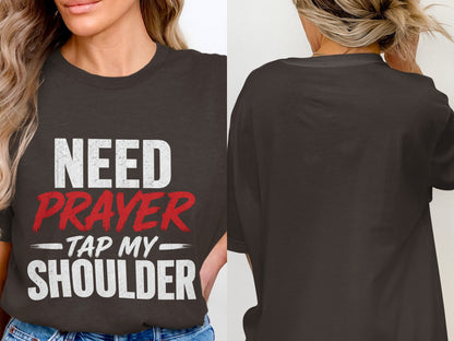 Dark gray t-shirt with white and red text: "NEED PRAYER - TAP MY SHOULDER"