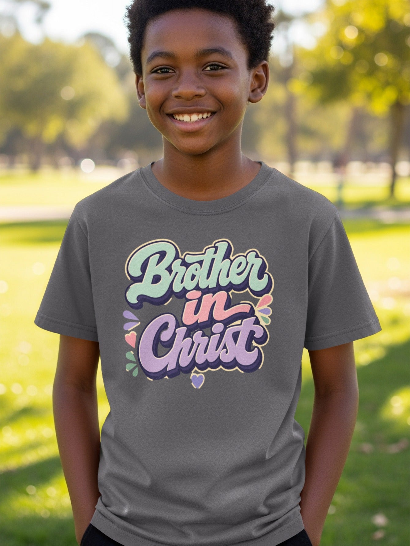 Young boy in gray t-shirt with "Brother in Christ" text and colorful graphic.