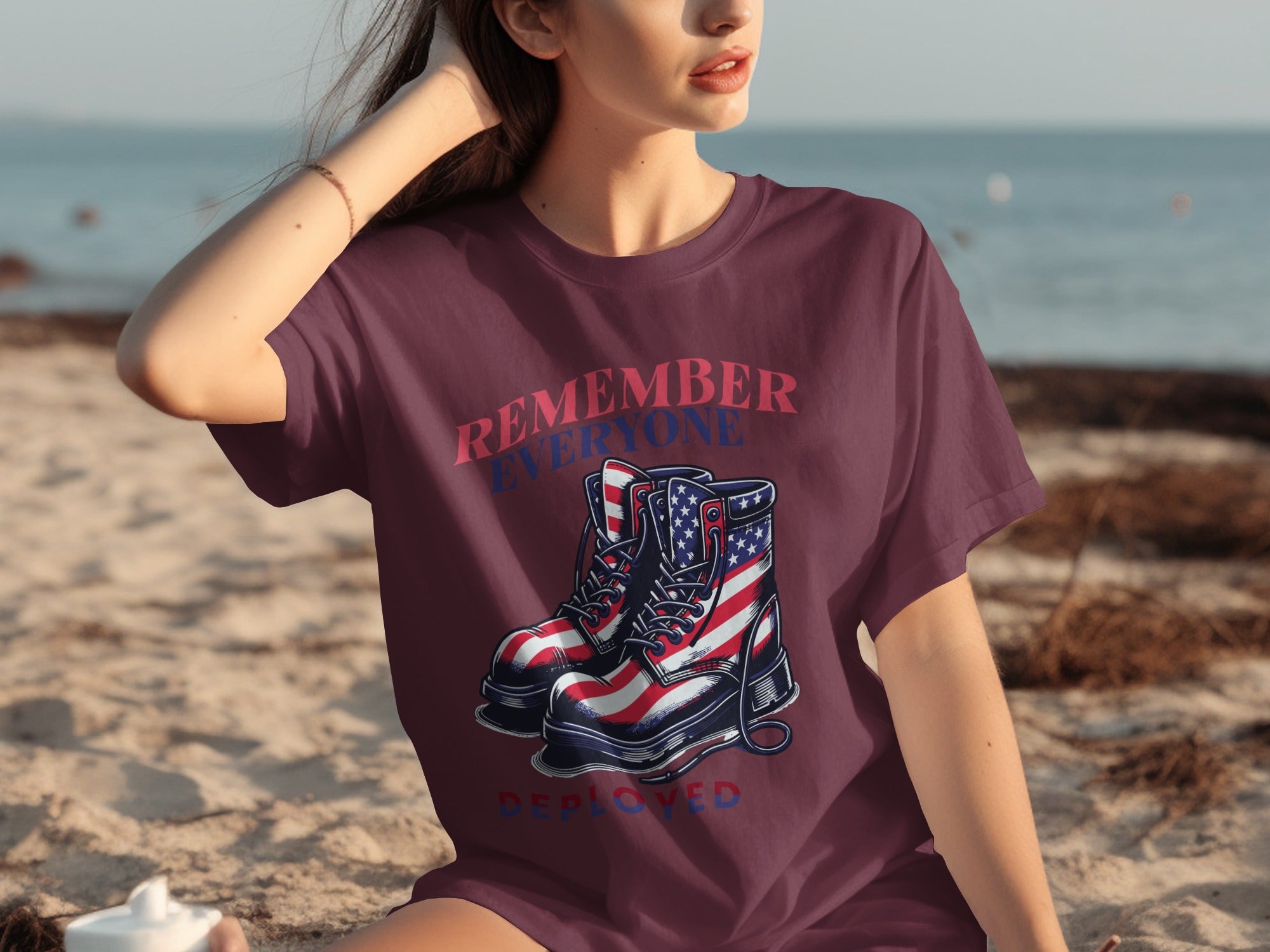 Maroon t-shirt with boots featuring American flag, "Remember Everyone Deployed" text.