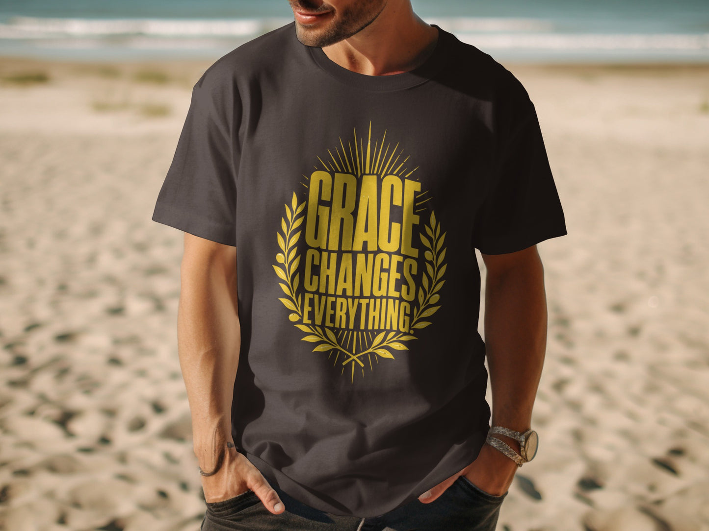 Dark t-shirt with gold text "GRACE CHANGES EVERYTHING" in laurel wreath design