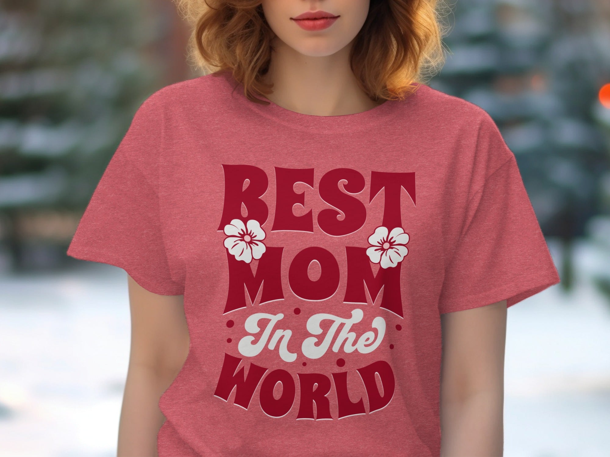 Red t-shirt with large red text "BEST MOM In The WORLD" and white flower accents.