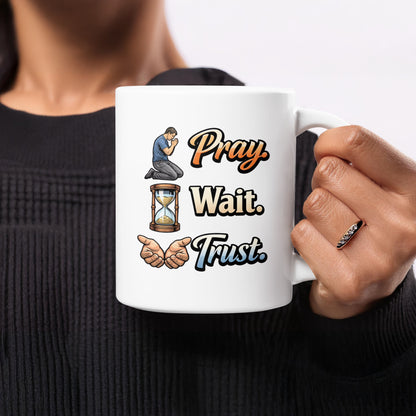 Mug with "Pray. Wait. Trust." text and illustrations of praying hands, hourglass, and praying person.