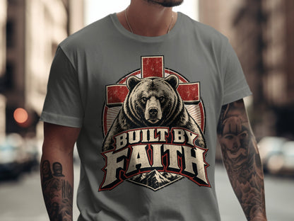 T-shirt graphic featuring a bear above text "Built by Faith" with mountains.