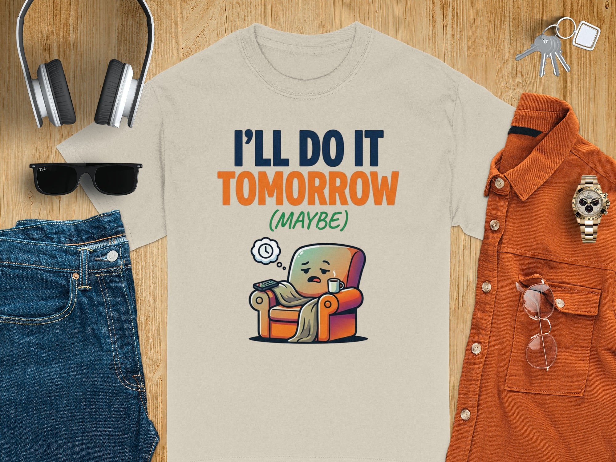 T-shirt with text "I'LL DO IT TOMORROW (MAYBE)" and cartoon of person in recliner.