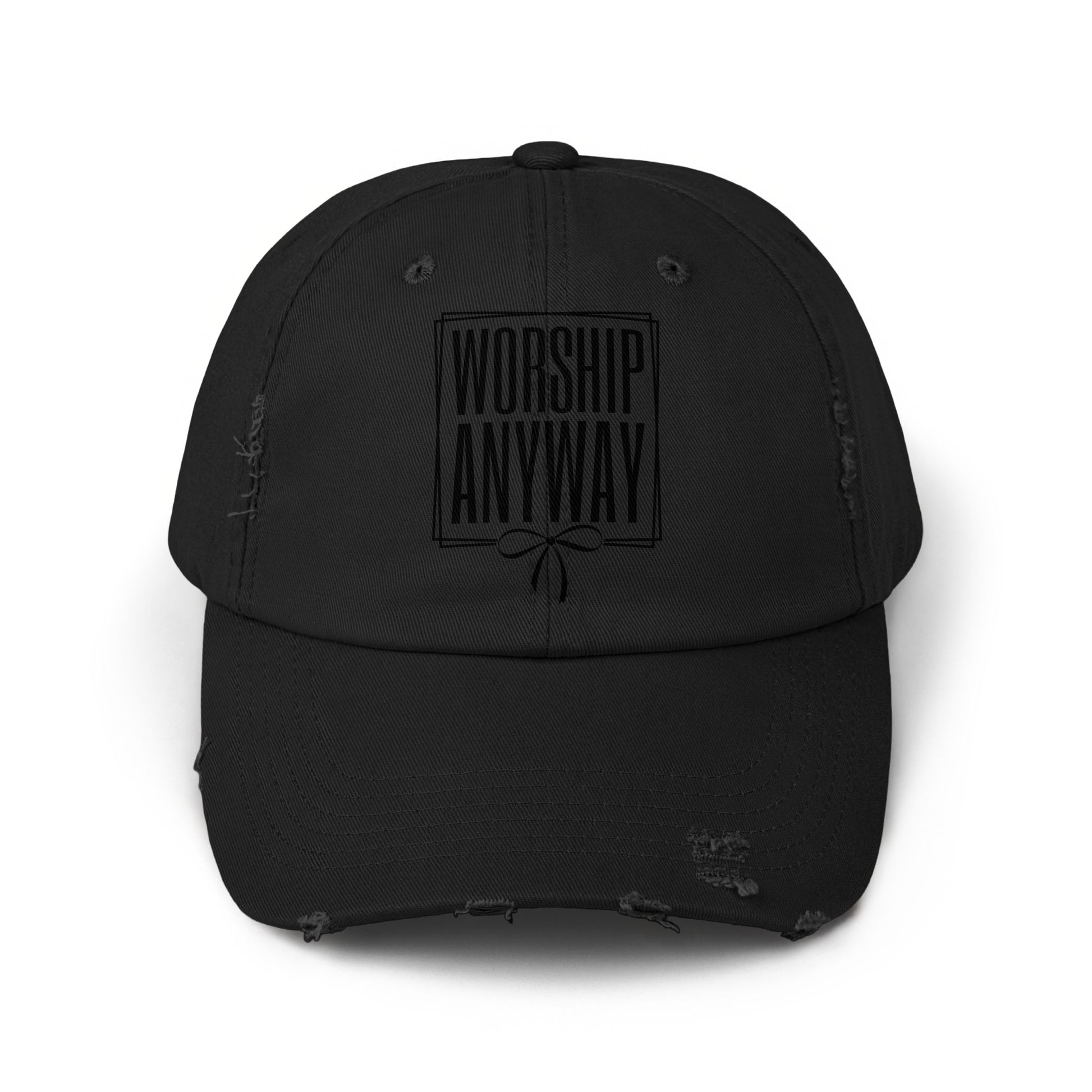 Black distressed baseball cap with "Worship Anyway" text and bow design.