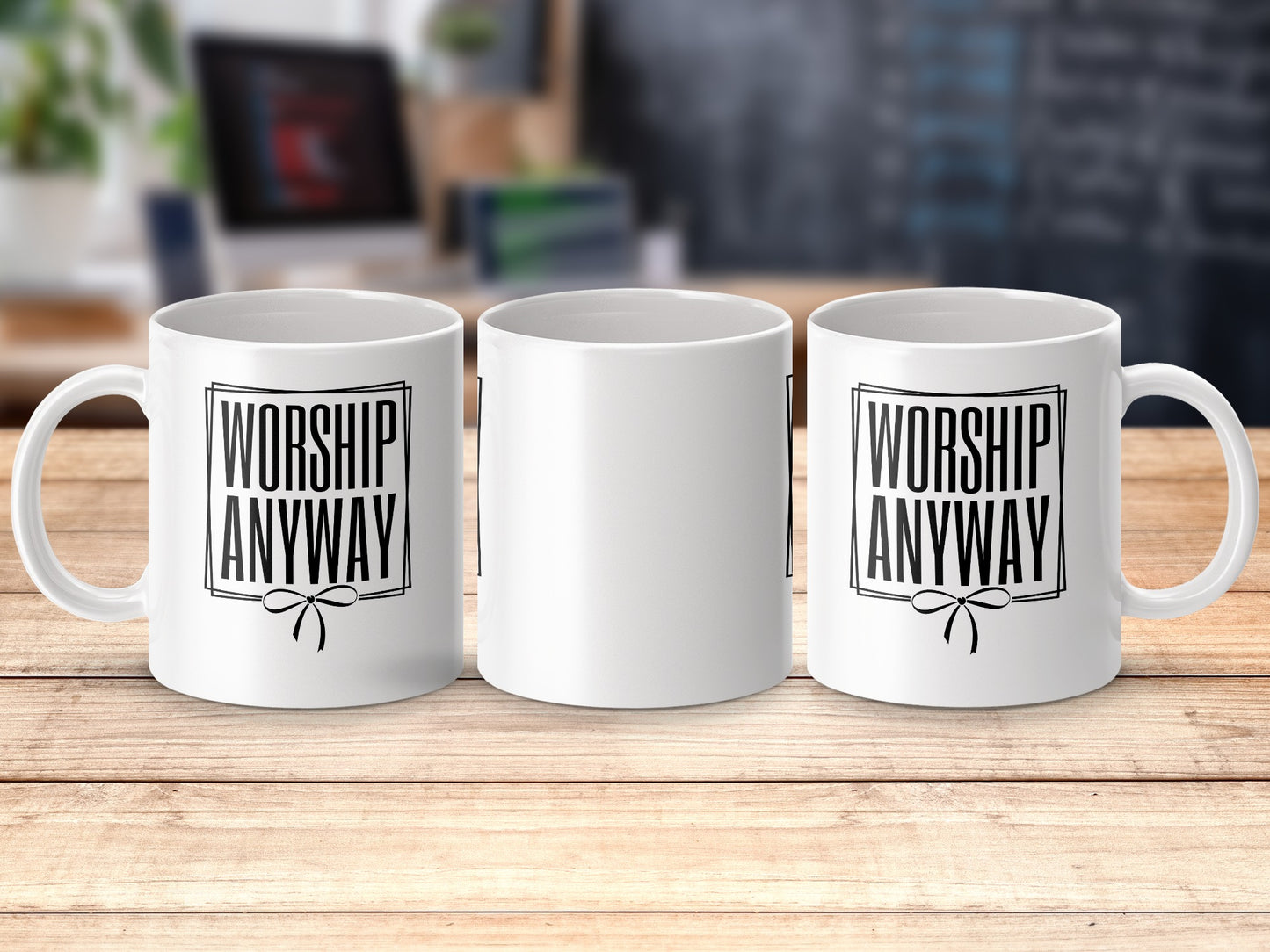 White mugs on a wooden surface with text "WORSHIP ANYWAY".