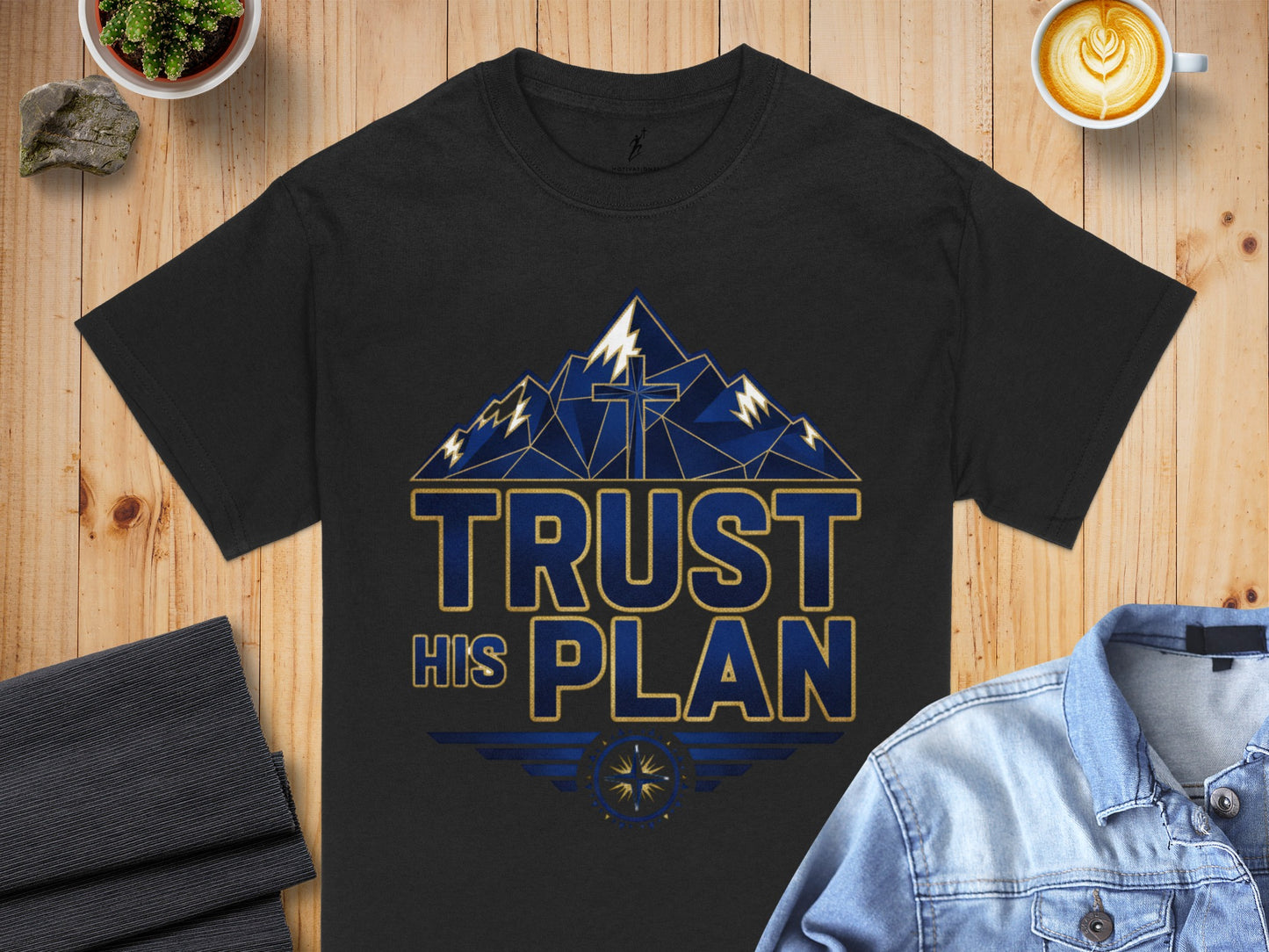 Black t-shirt with mountains and a cross graphic reading "TRUST HIS PLAN".