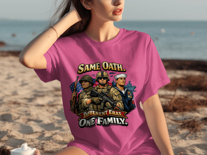 Pink t-shirt with military graphic reading "Same Oath. Different Eras. One Family."