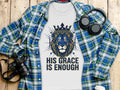 White t-shirt with a blue and gold lion graphic and text "His Grace Is Enough".