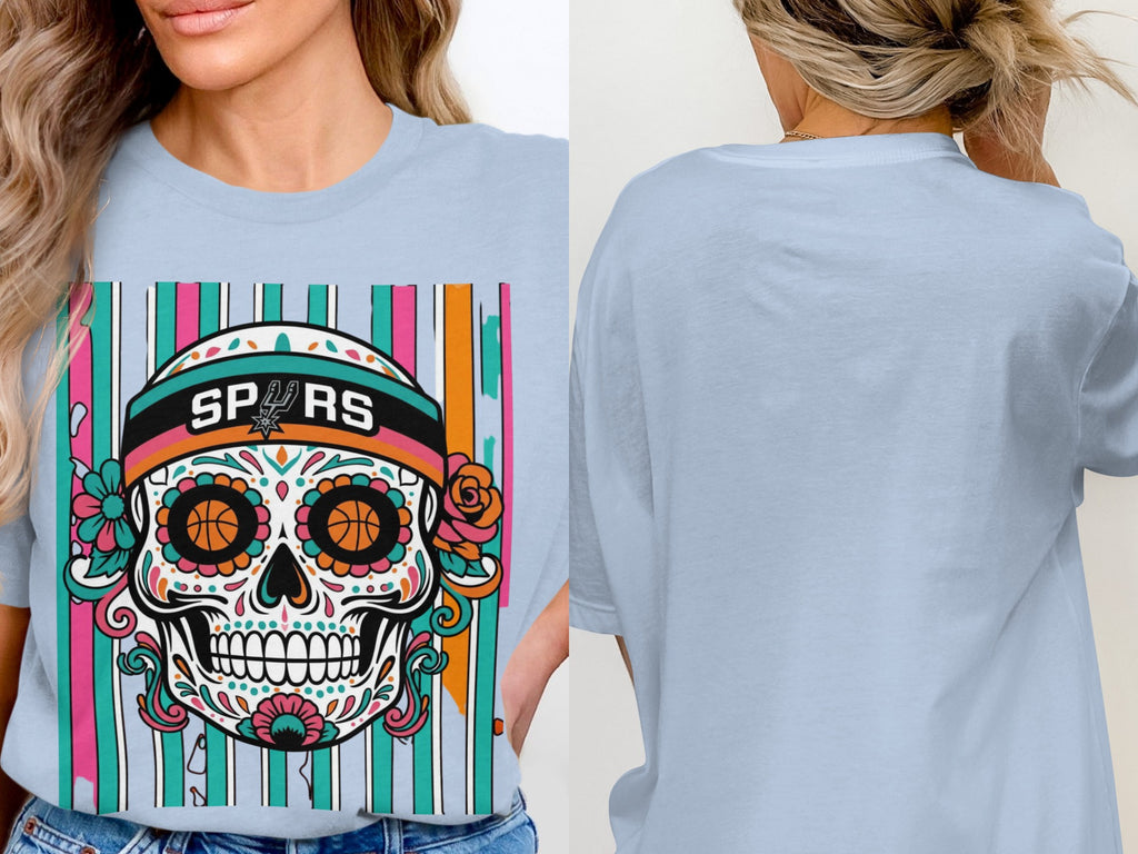 Light blue t-shirt with a colorful sugar skull graphic featuring Spurs logo.