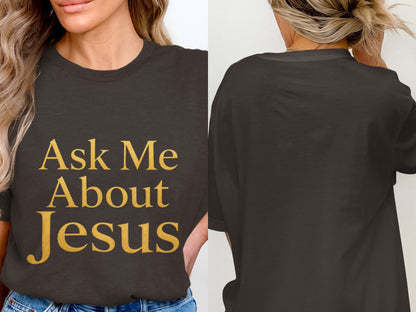 Dark grey t-shirt with gold text "Ask Me About Jesus" on front.