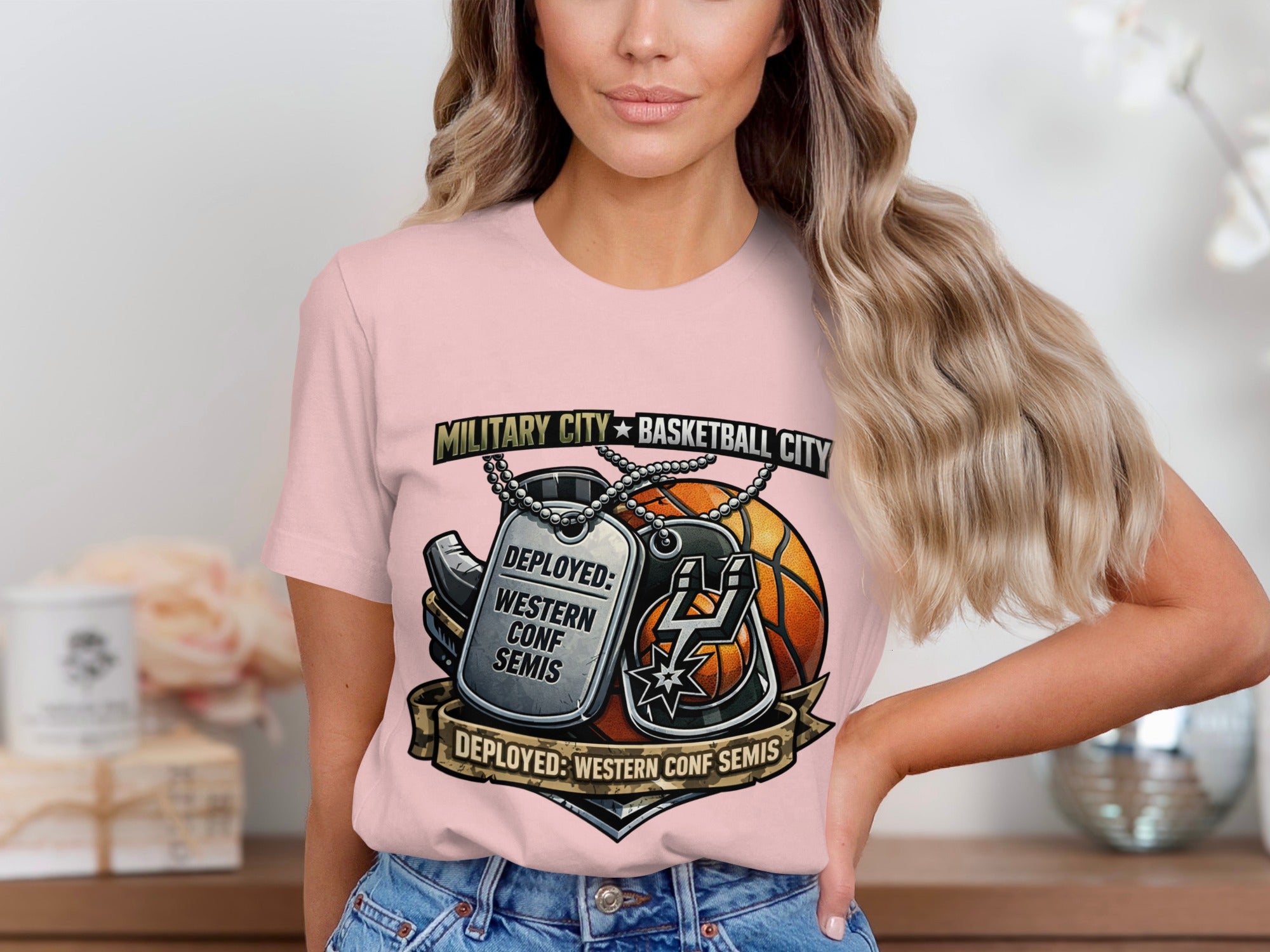 Pink t-shirt with graphic that says "Military City Basketball City" and dog tags.