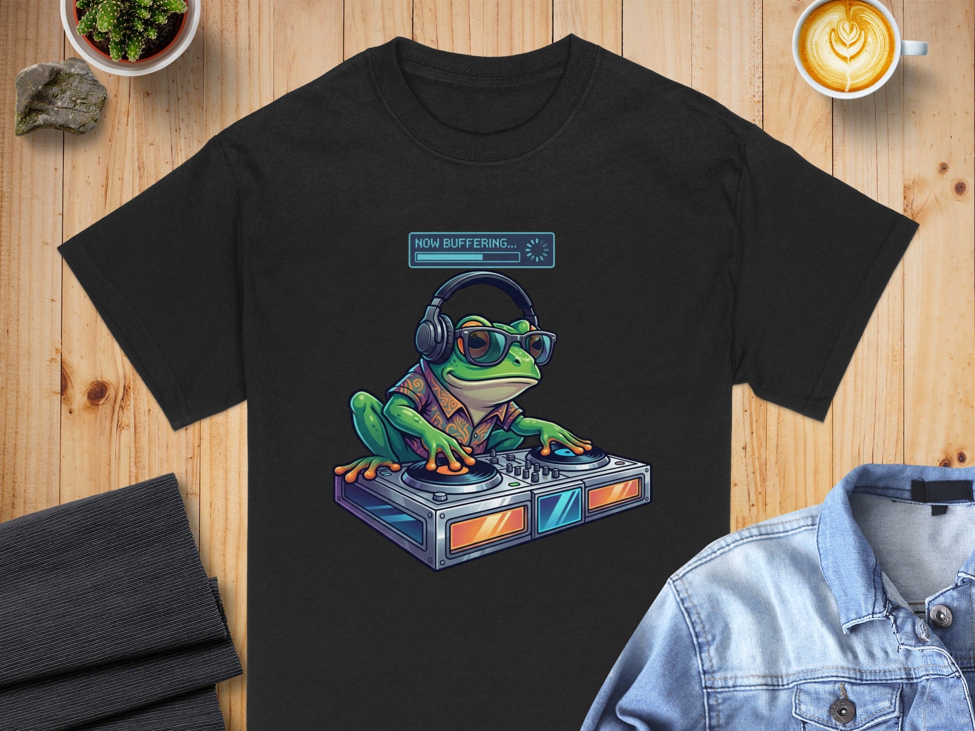 Black t-shirt featuring a frog DJ wearing headphones with "NOW BUFFERING..." text.