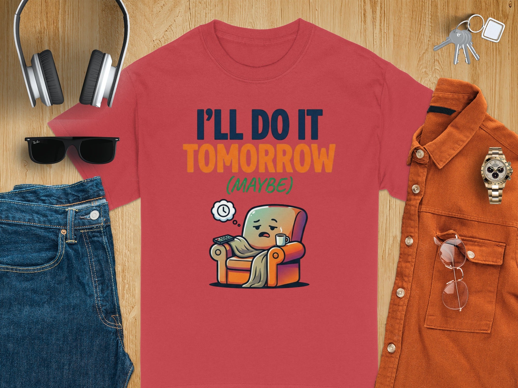 Red t-shirt with text "I'll do it tomorrow (maybe)" and a lazy character in a chair.