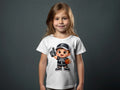 Young girl wearing a white t-shirt with a cartoon basketball player graphic.