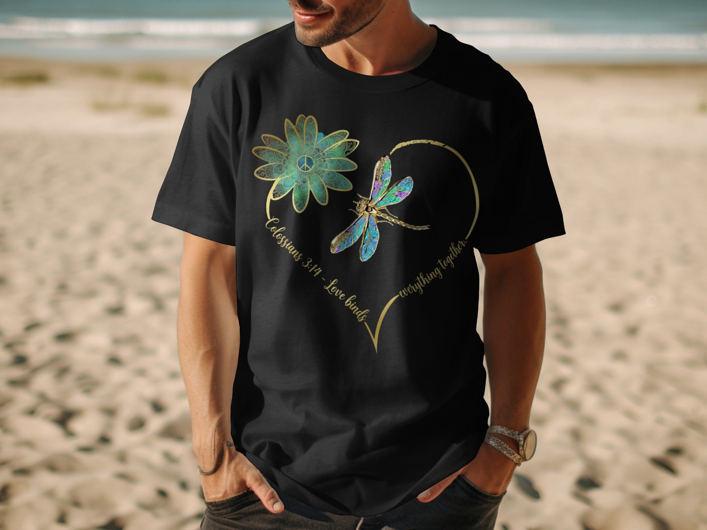 Black t-shirt with flower, dragonfly, and text "Colossians 3:14 - Love binds everything together."