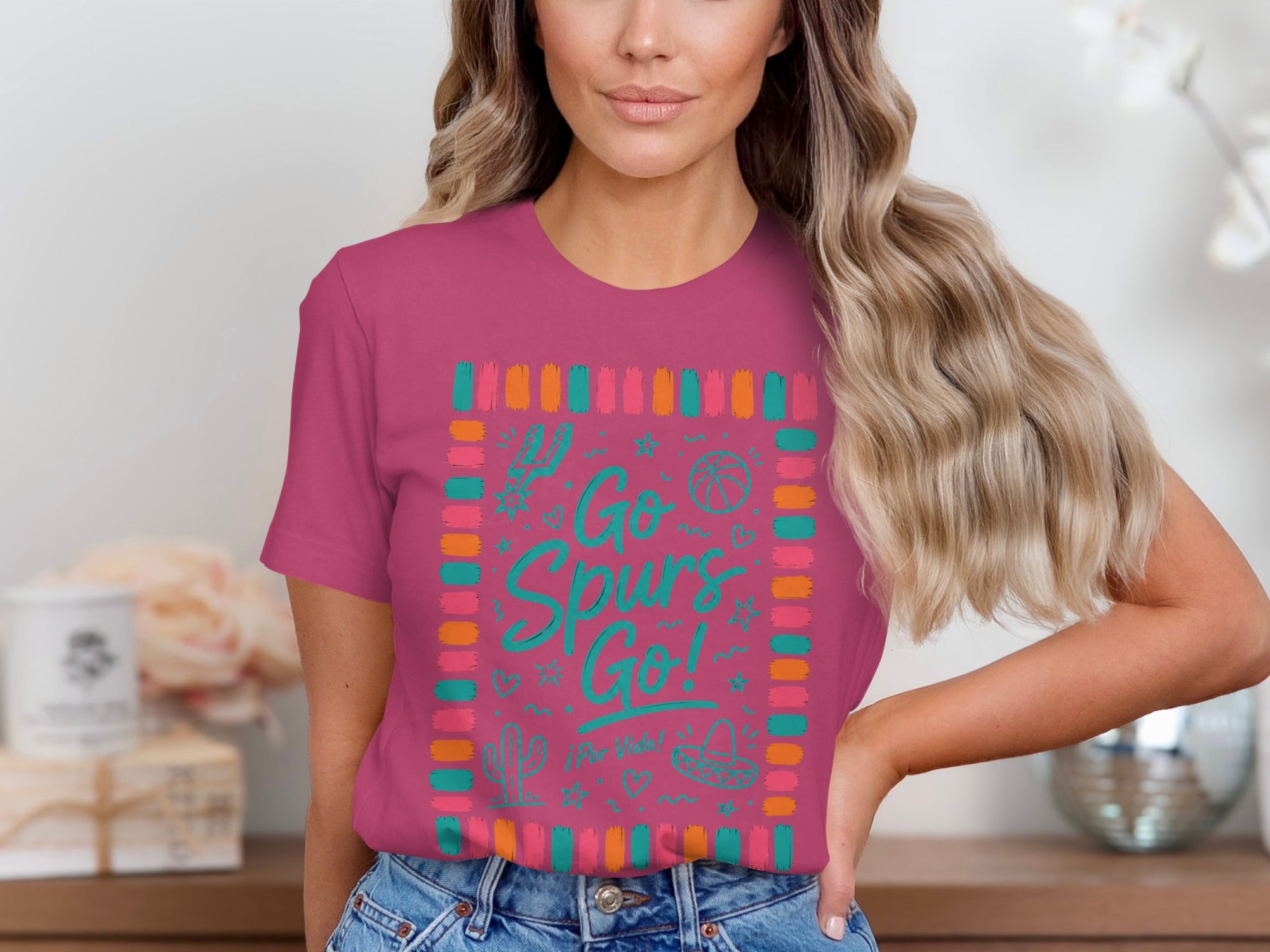 Pink t-shirt with "Go Spurs Go!" graphic and desert-themed icons.
