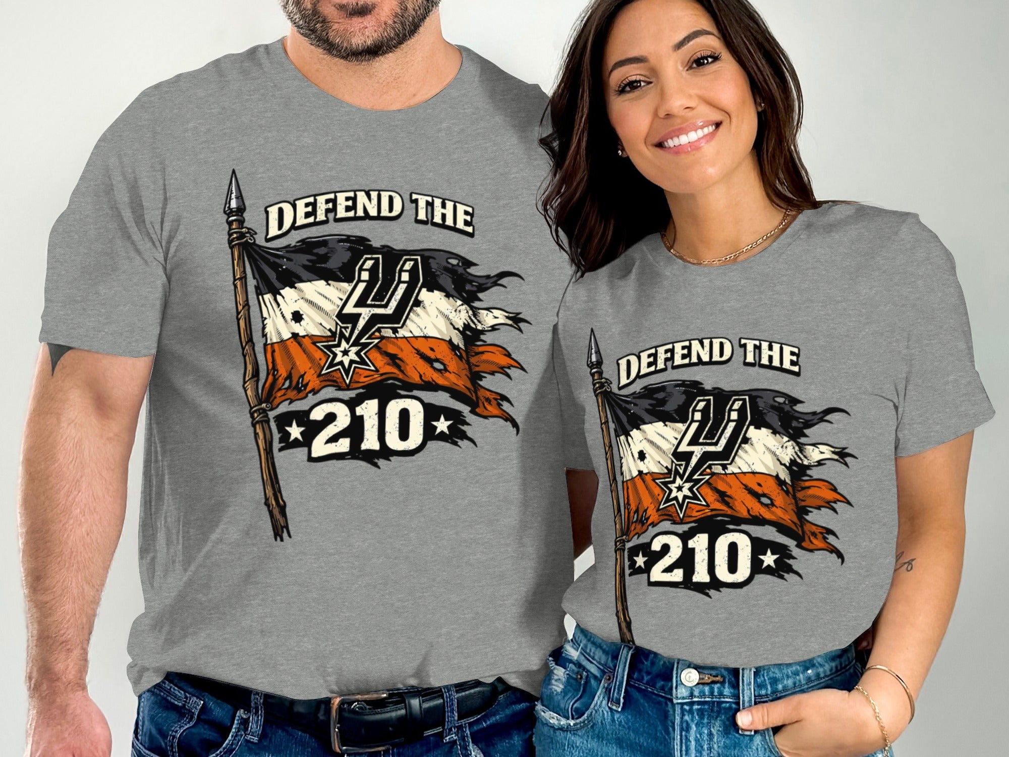 Gray t-shirts with "DEFEND THE 210" and torn flag design featuring Spurs logo.