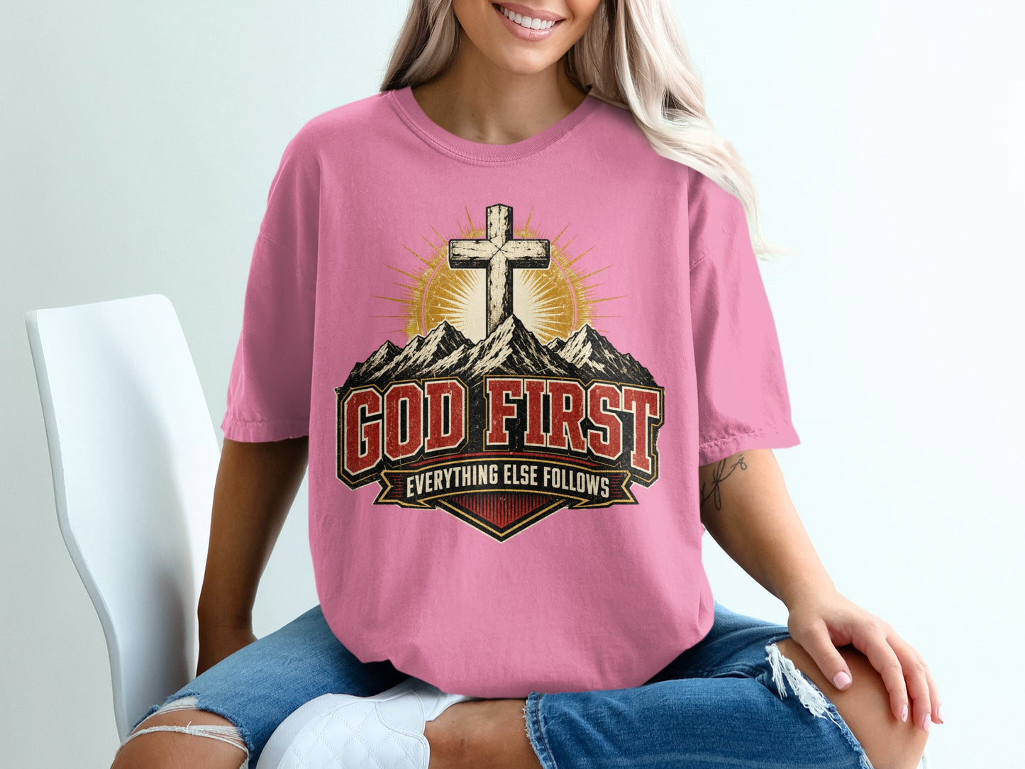 Pink t-shirt with "God First Everything Else Follows" text and cross design.