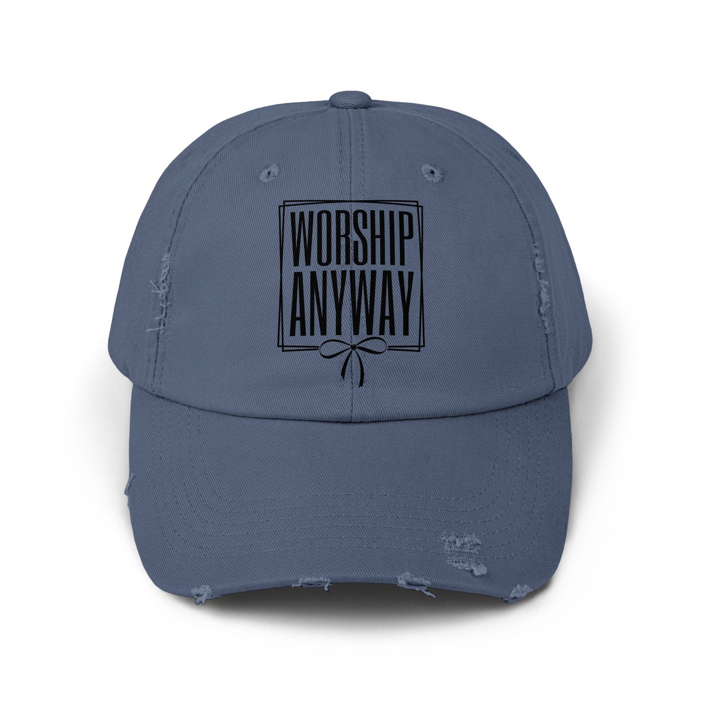 Distressed blue baseball cap with "WORSHIP ANYWAY" text and a bow detail.