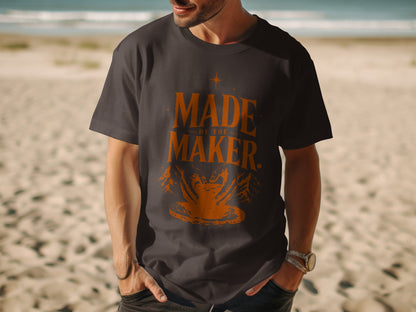 Dark grey t-shirt with orange text "MADE BY THE MAKER" and pottery design.